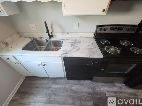A kitchen with a sink and stove top oven.