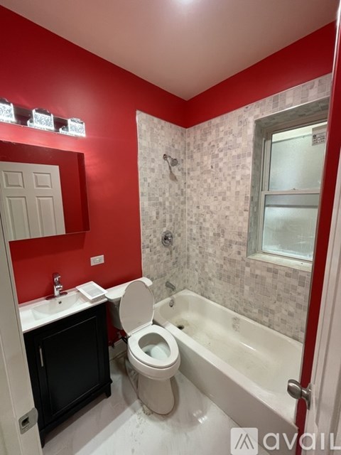 A bathroom with red walls and a white toilet.