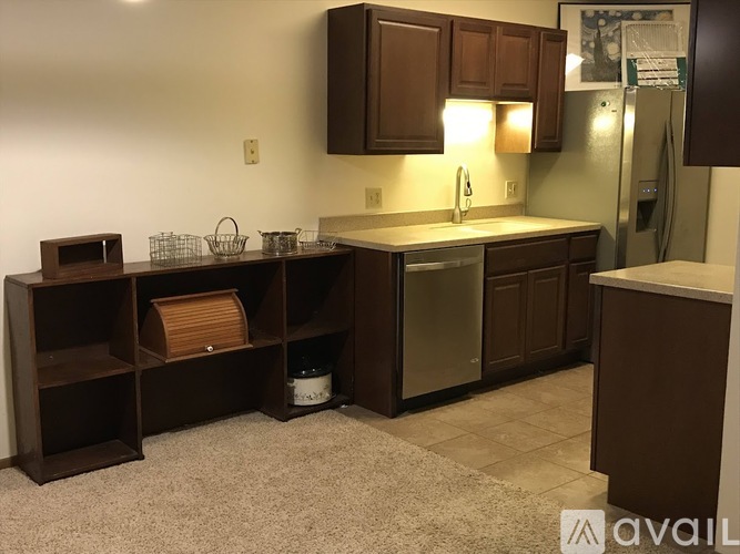 A kitchen with brown cabinets and a white countertop.