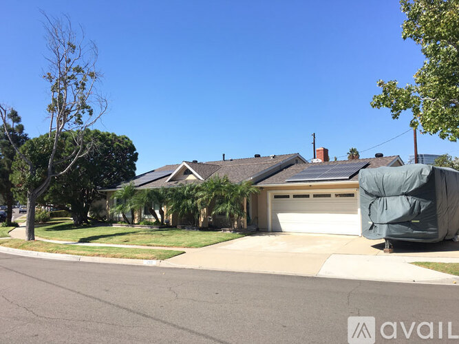 A house with a garage door covered in a green tarp.
