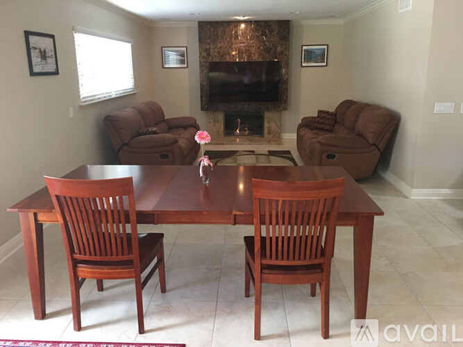 A living room with a brown table and chairs.