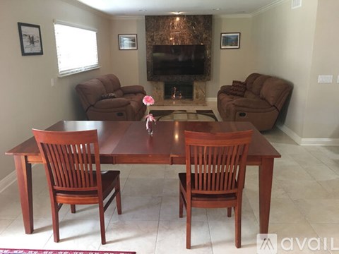 A living room with a brown table and chairs.