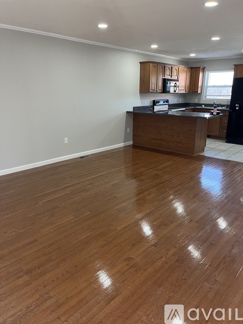 A kitchen with wooden floors and cabinets is available for rent.