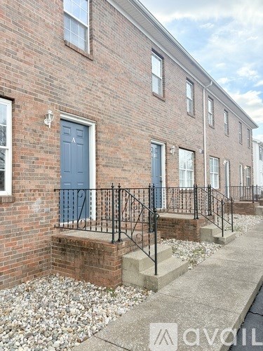 A brick building with a blue door and windows.
