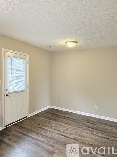 A room with a door and a window.