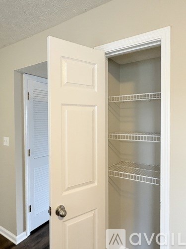 A white door with a glass panel and shelves.