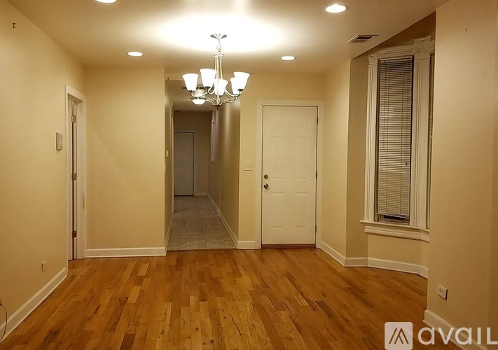 A room with wooden floors and a chandelier.