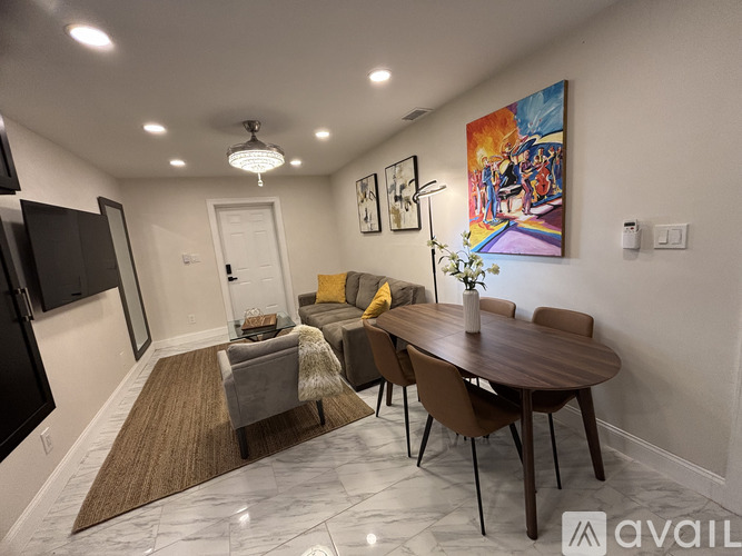 A modern dining room with a wooden table and chairs.