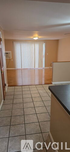 A room with a black countertop and tiled floor.
