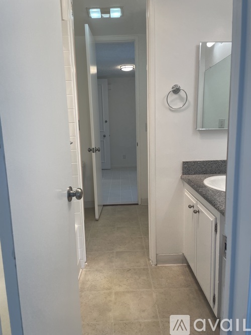 A bathroom with a sink, mirror, and toilet.