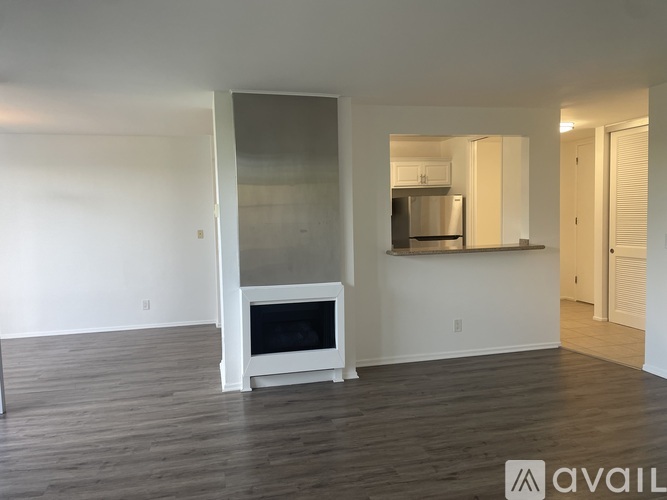 A modern living room with a television and wooden flooring.