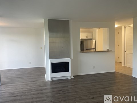 A modern living room with a television and wooden flooring.