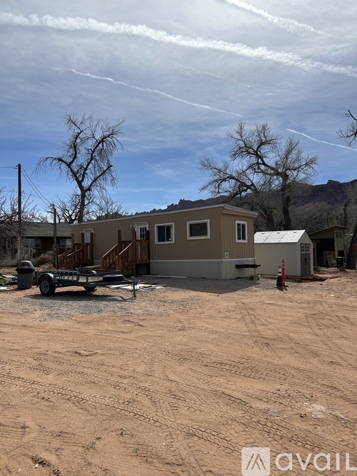 A trailer is parked in front of a house.