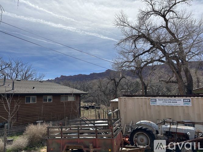 A truck is parked in front of a building with a sign that reads "Quick Space Nevada.".