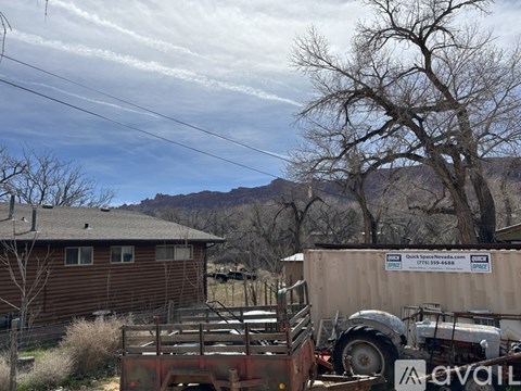 A truck is parked in front of a building with a sign that reads "Quick Space Nevada.".