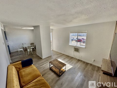 A living room with a brown couch and a coffee table.