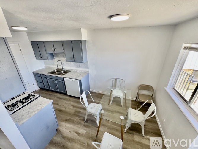 A kitchen with white chairs and a white stove.