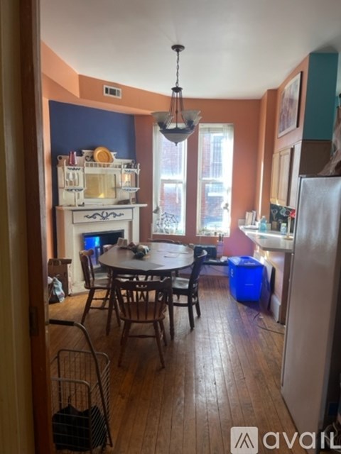A kitchen with a table and chairs in the middle of the room.