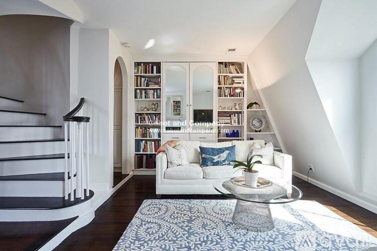 A living room with a white couch and a coffee table.