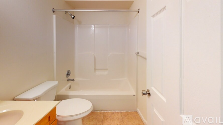 A bathroom with a toilet, sink, and bathtub.