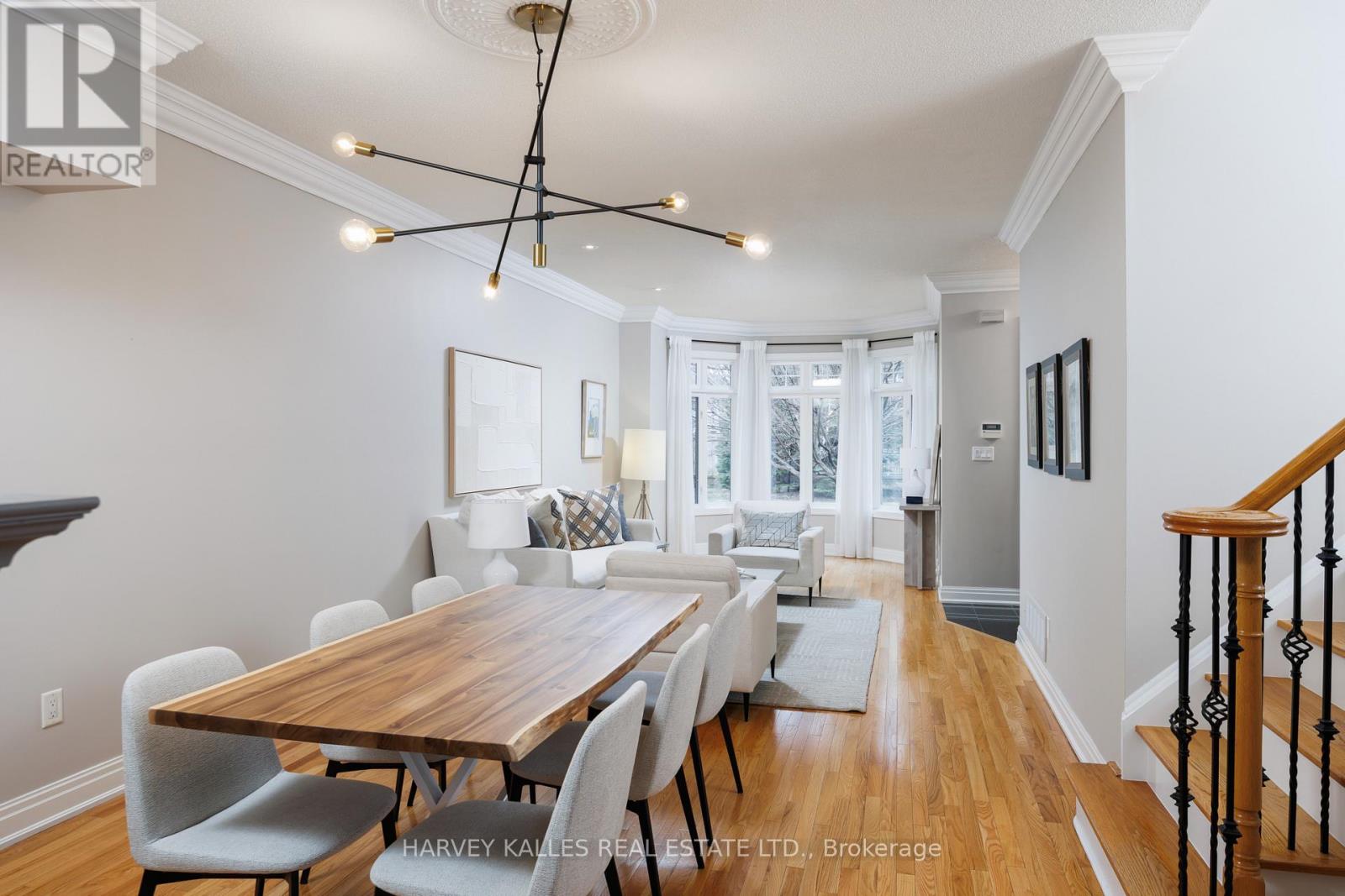 A dining room with a wooden table and chairs.