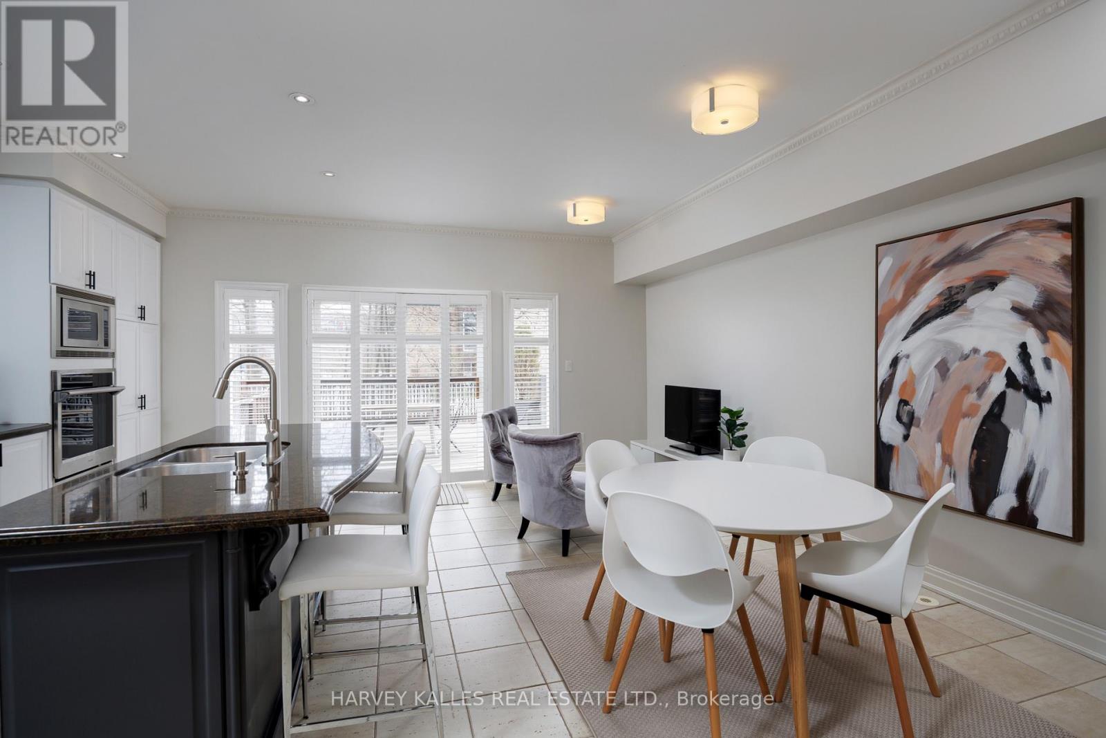 A modern kitchen with a dining table and chairs.