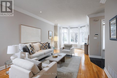 A well-lit living room with a white sofa and a coffee table.