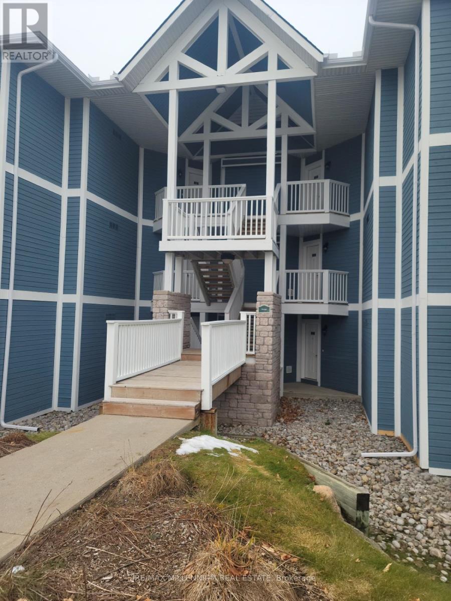 A blue and white building with a balcony and stairs.
