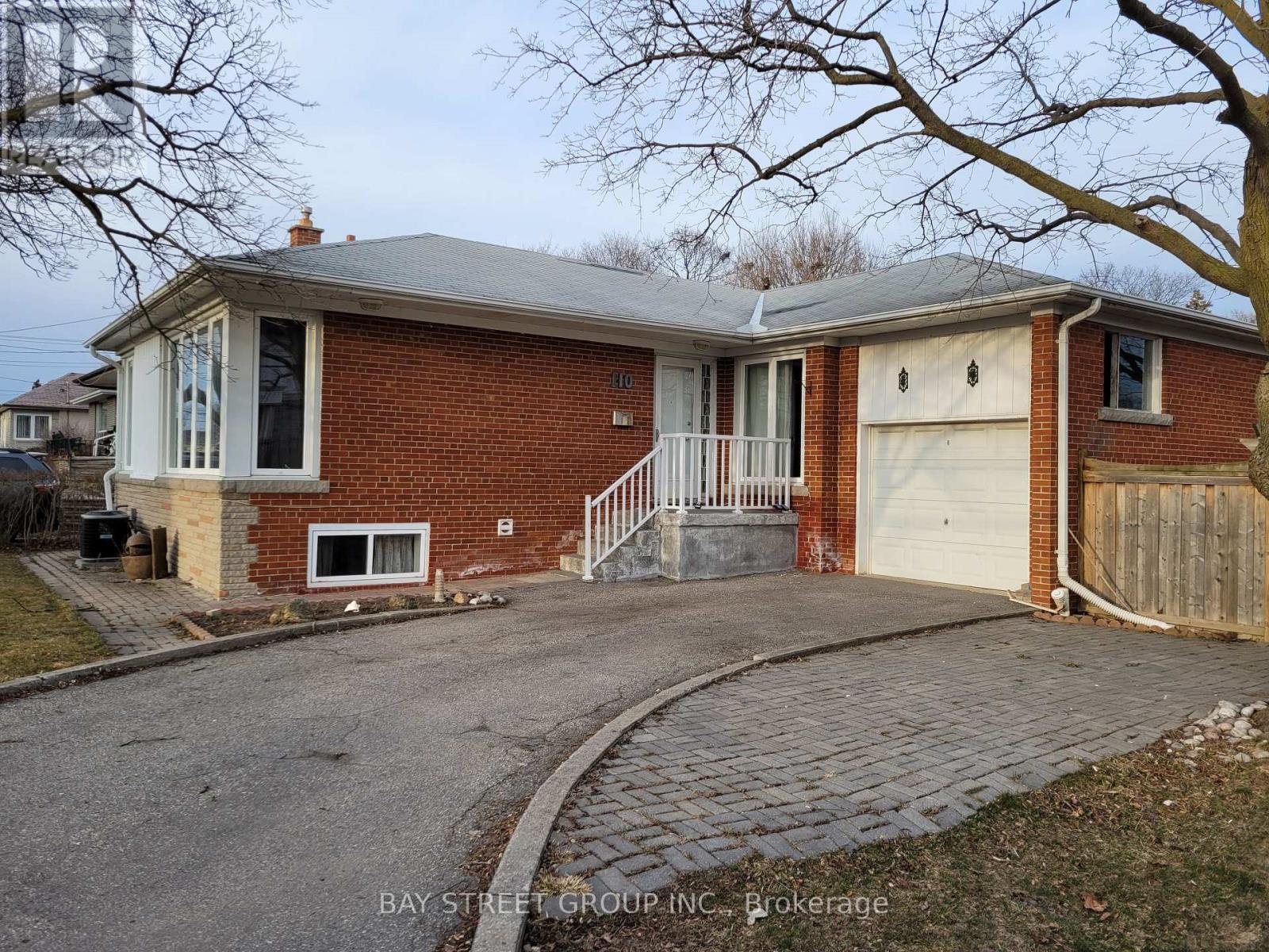 A brick house with a garage and a driveway.