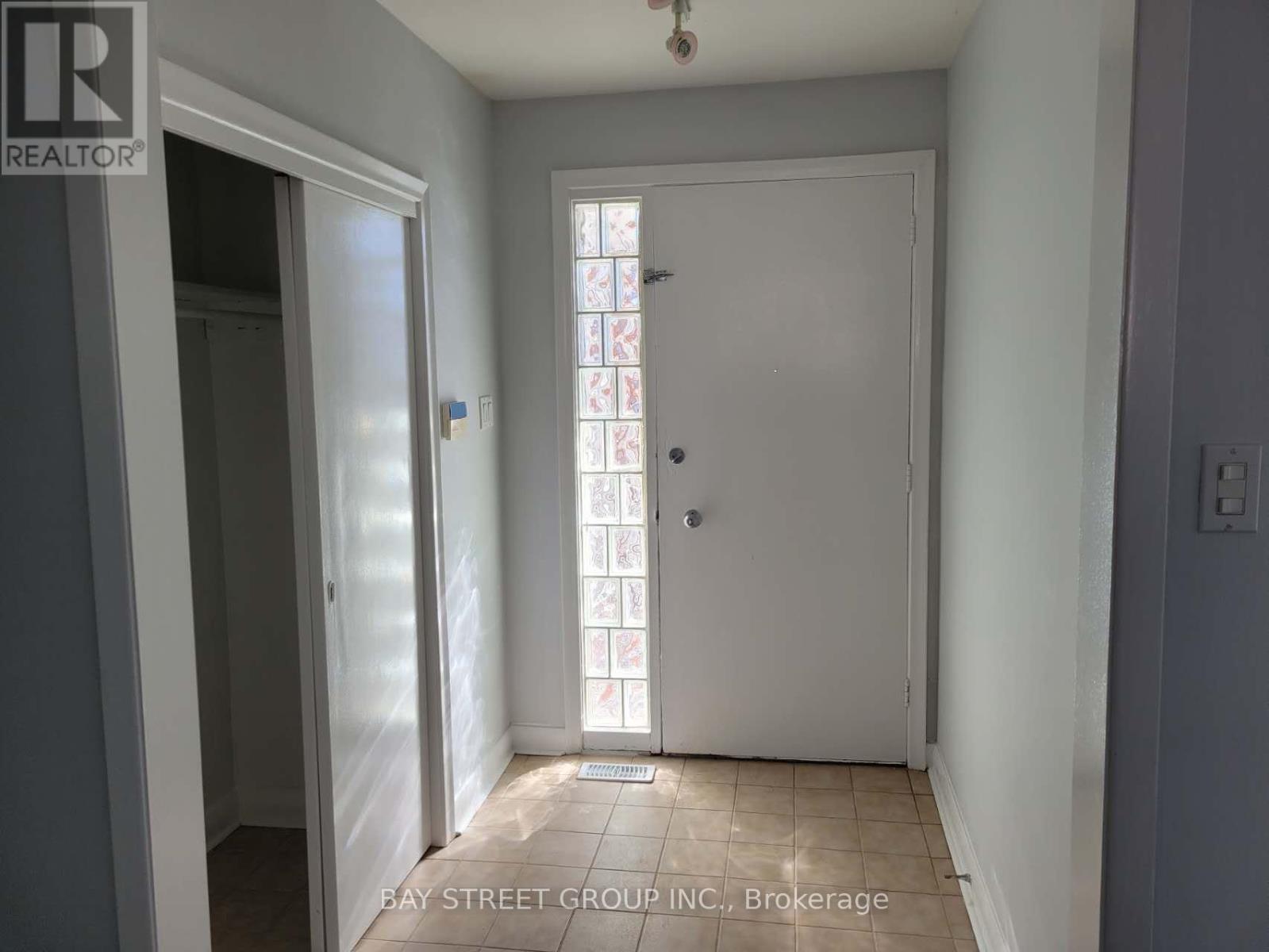 A white door with a glass window is in the middle of a room.