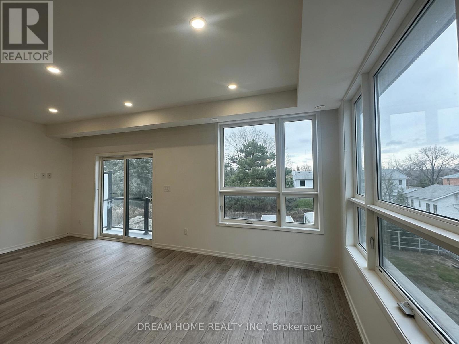 A room with a large window and sliding glass doors.
