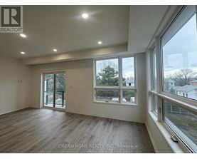 A room with a large window and sliding glass doors.