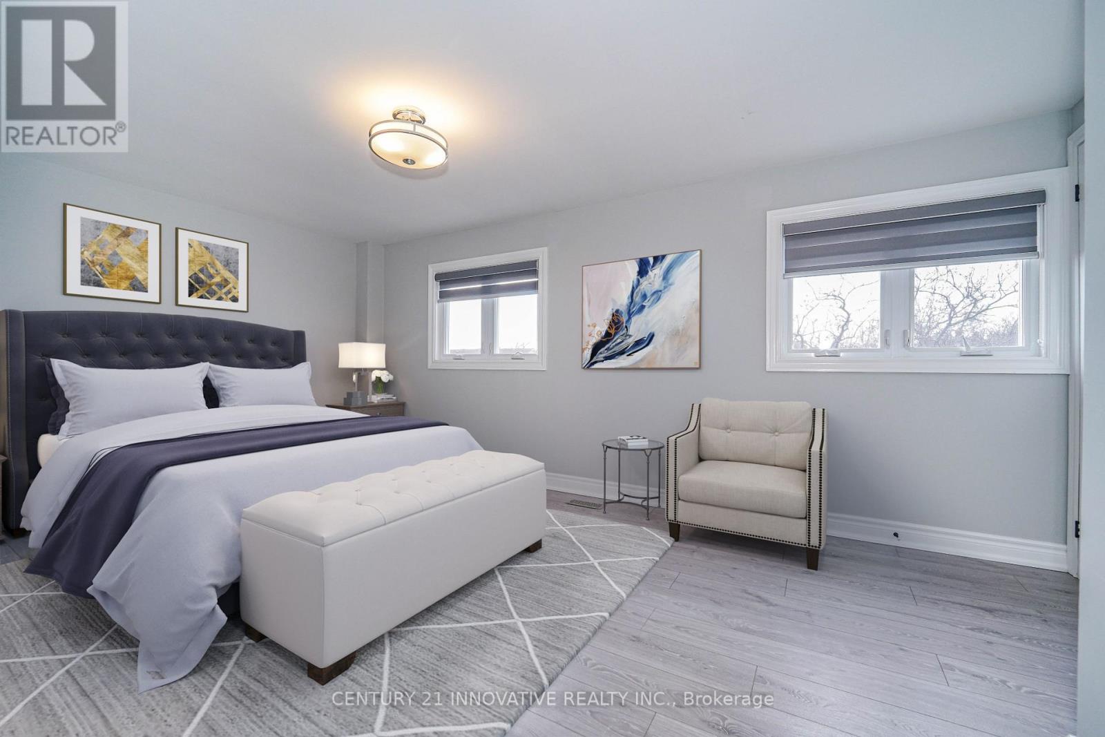 A bedroom with a large bed and a chair.