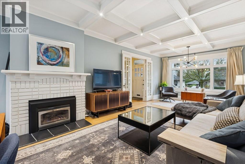 A living room with a fireplace and a television.