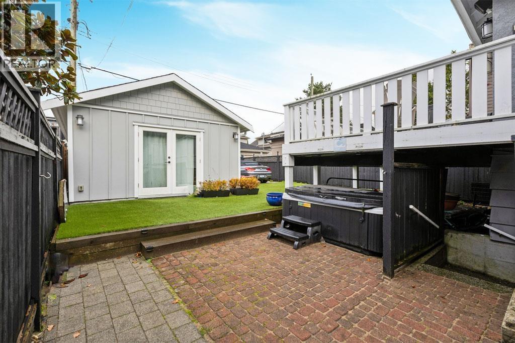 A backyard with a hot tub and a shed.