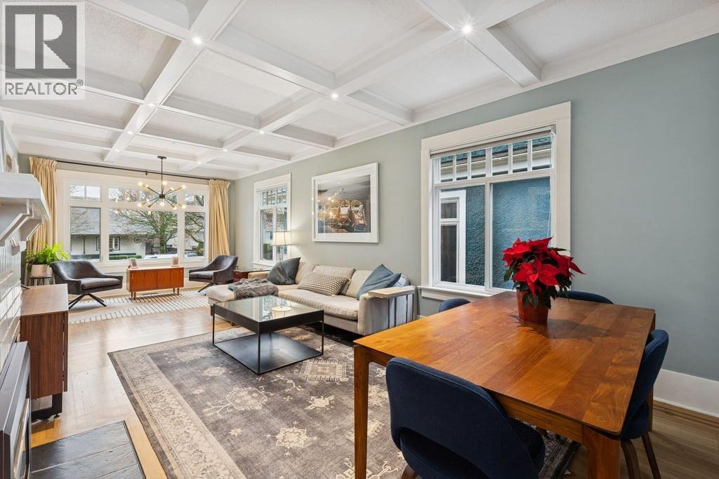 A well-lit living room with a dining table and chairs.