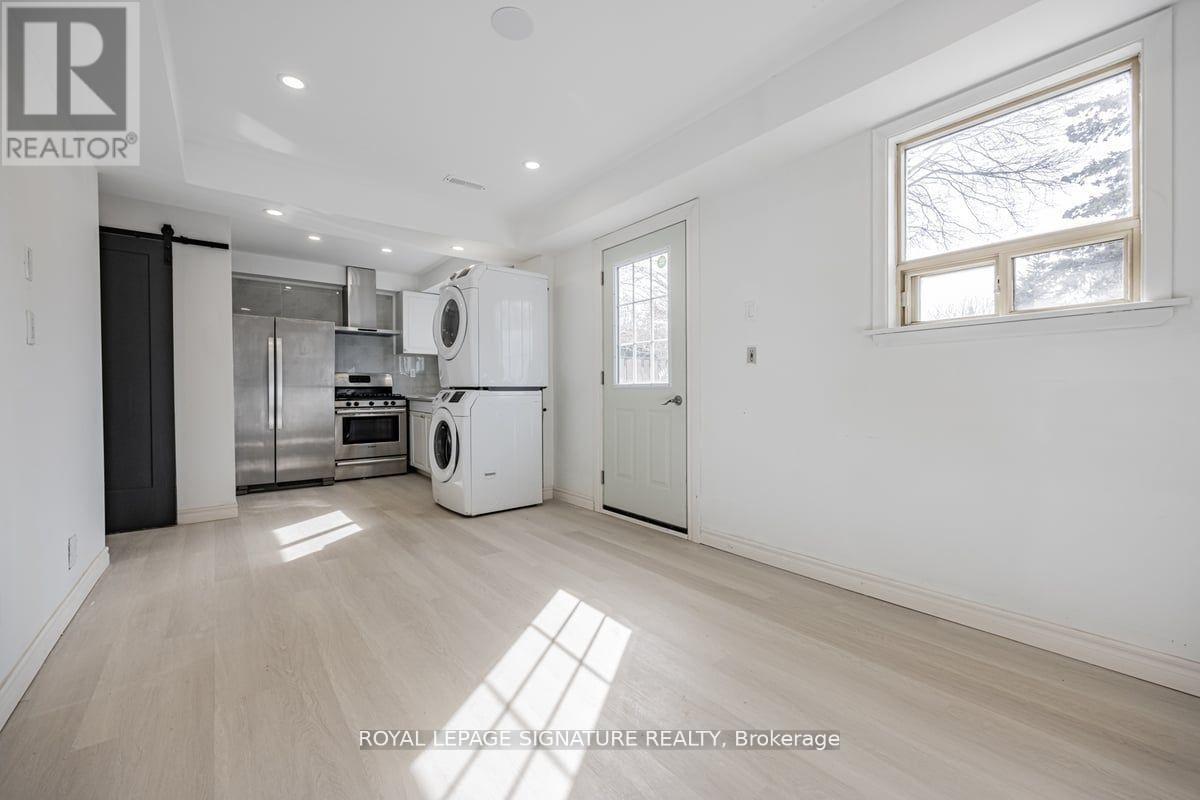A spacious room with a washer and dryer in it.