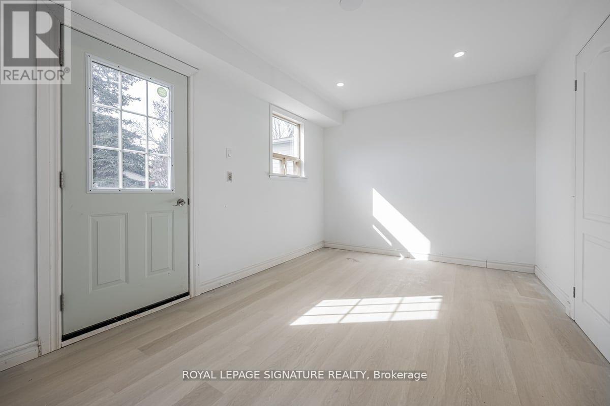 A white room with a door and a window.