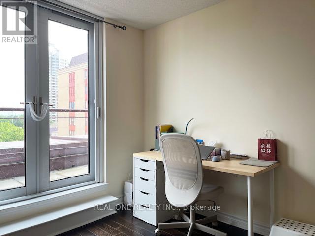 A room with a desk, chair, and window.