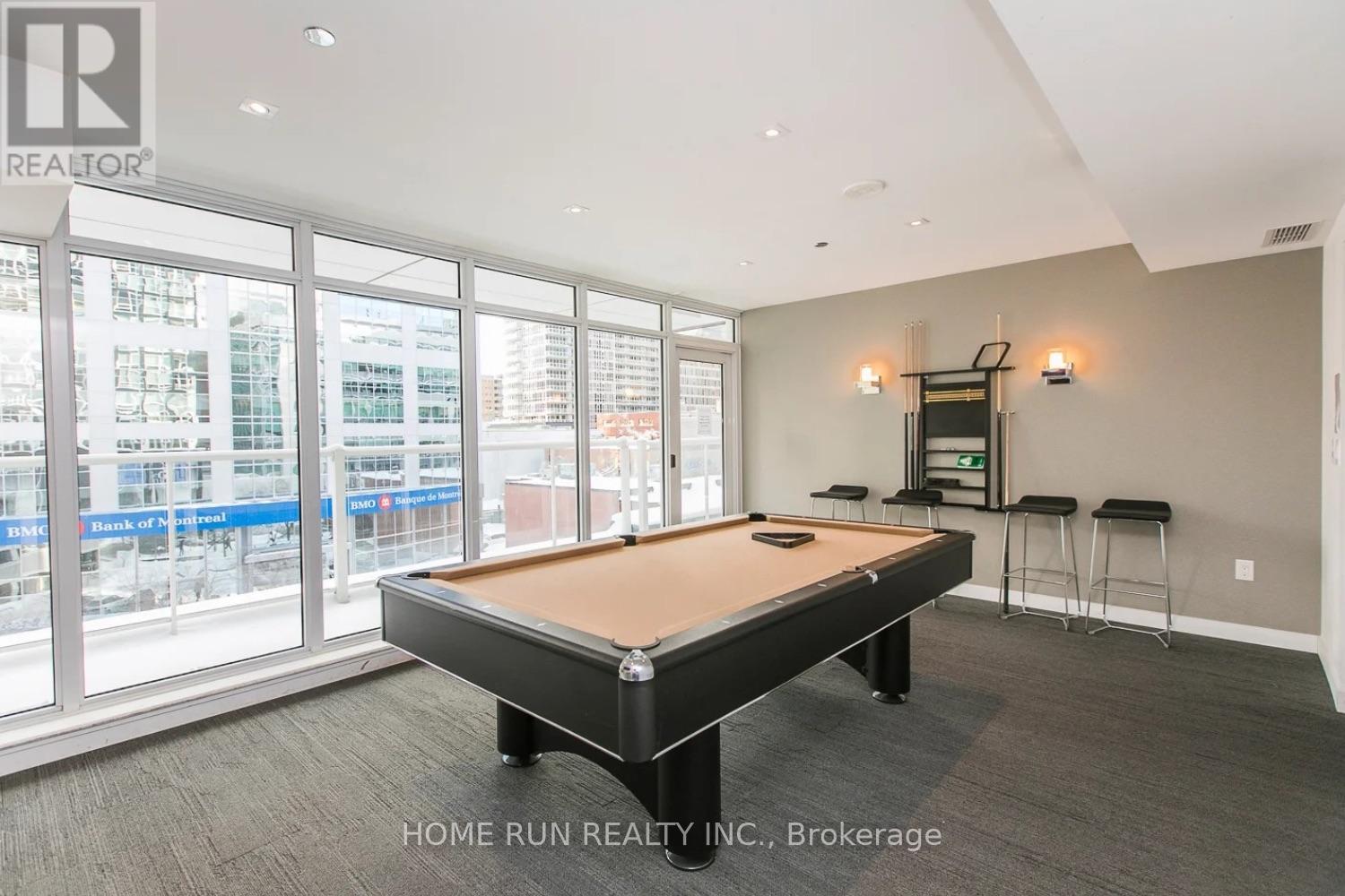 A pool table in a room with a view of the city.