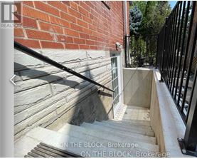 A set of stairs leading up to a black railing with the words "ON THE BLOCK, Brokerage" written on the image.