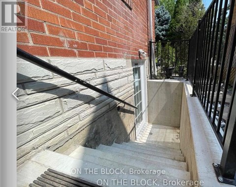 A set of stairs leading up to a black railing with the words "ON THE BLOCK, Brokerage" written on the image.