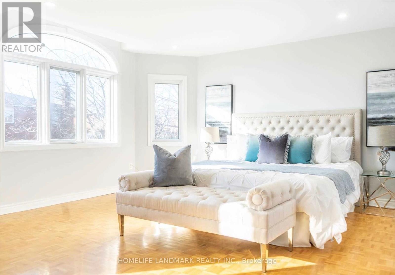 A bedroom with a large bed and a window.