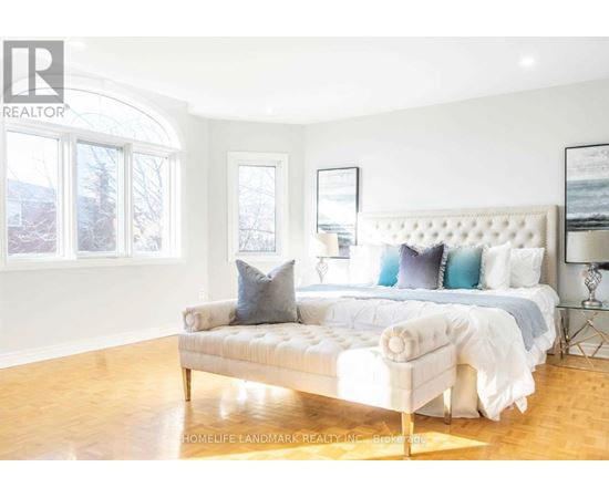 A bedroom with a large bed and a window.