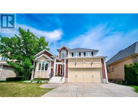 A large, two-story house with a garage is for sale.