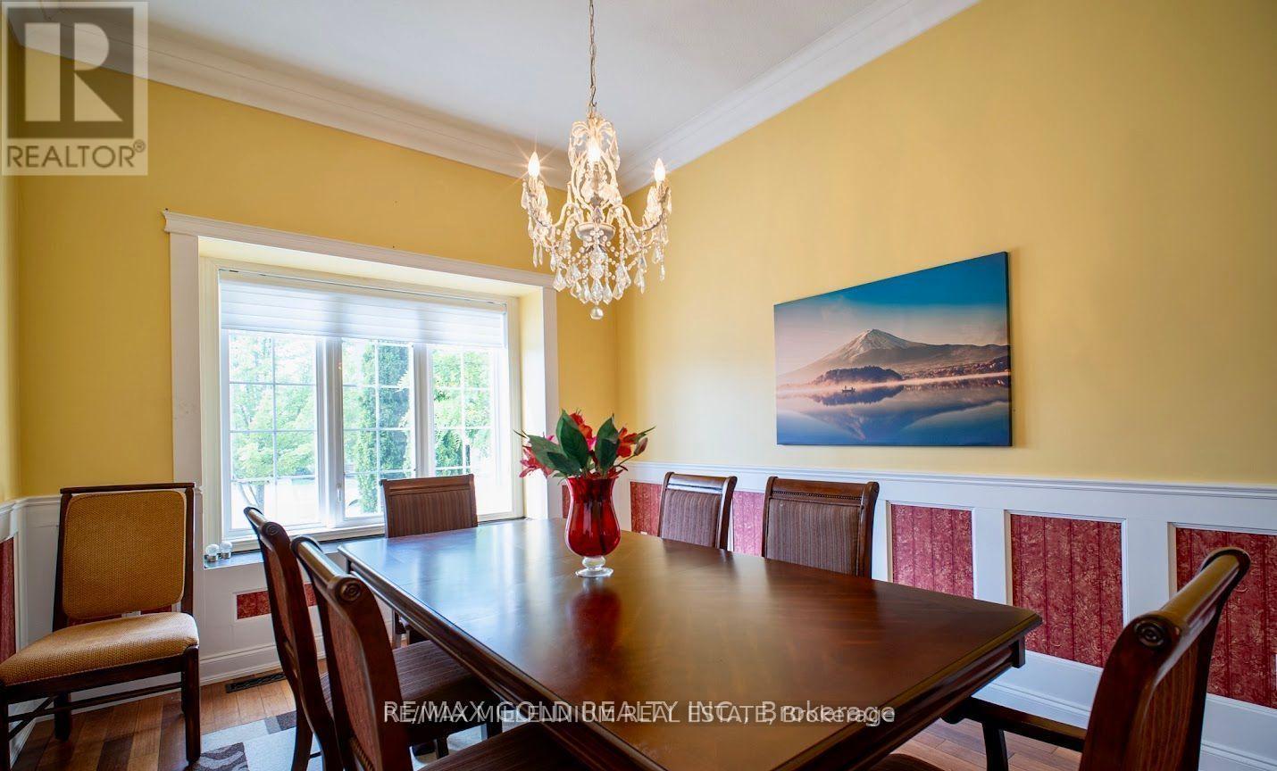 A dining room with a wooden table and chairs.