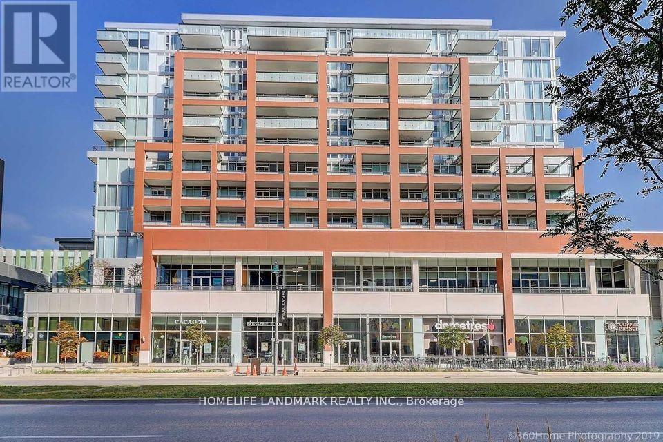 A multi-story building with a glass facade and a red brick exterior.