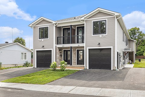 A two-story house with a garage on the ground floor.