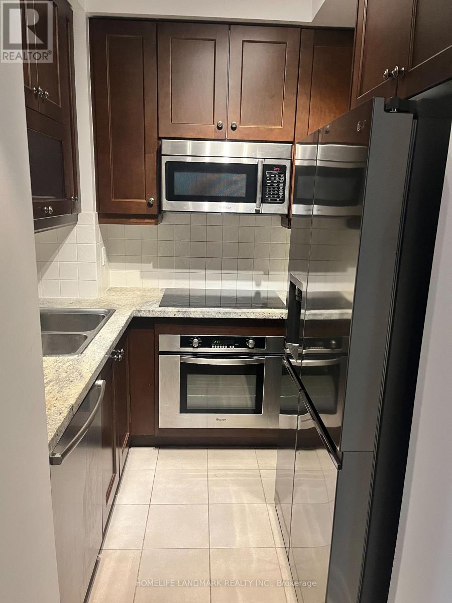 A kitchen with wooden cabinets and stainless steel appliances.