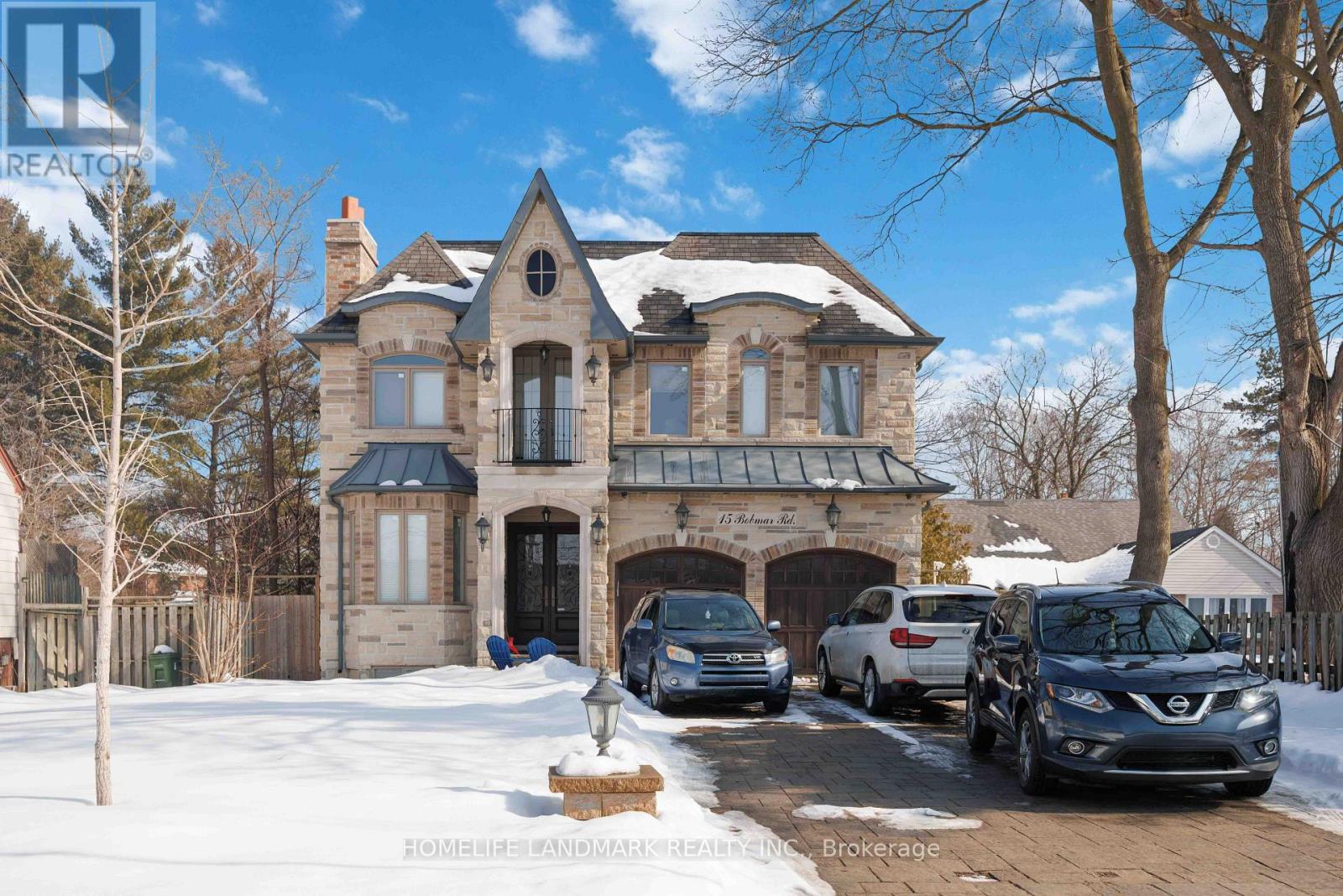 A large house with a carport and a car in front.